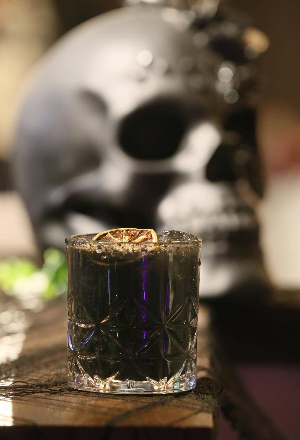 The Wednesday Adams cocktail, which features black currant liqueur, vodka, Kahlua coffee liqueur and ginger beer, is one of the Halloween-themed cocktails at The Daily Pressed, which has created a Halloween pop-up bar.