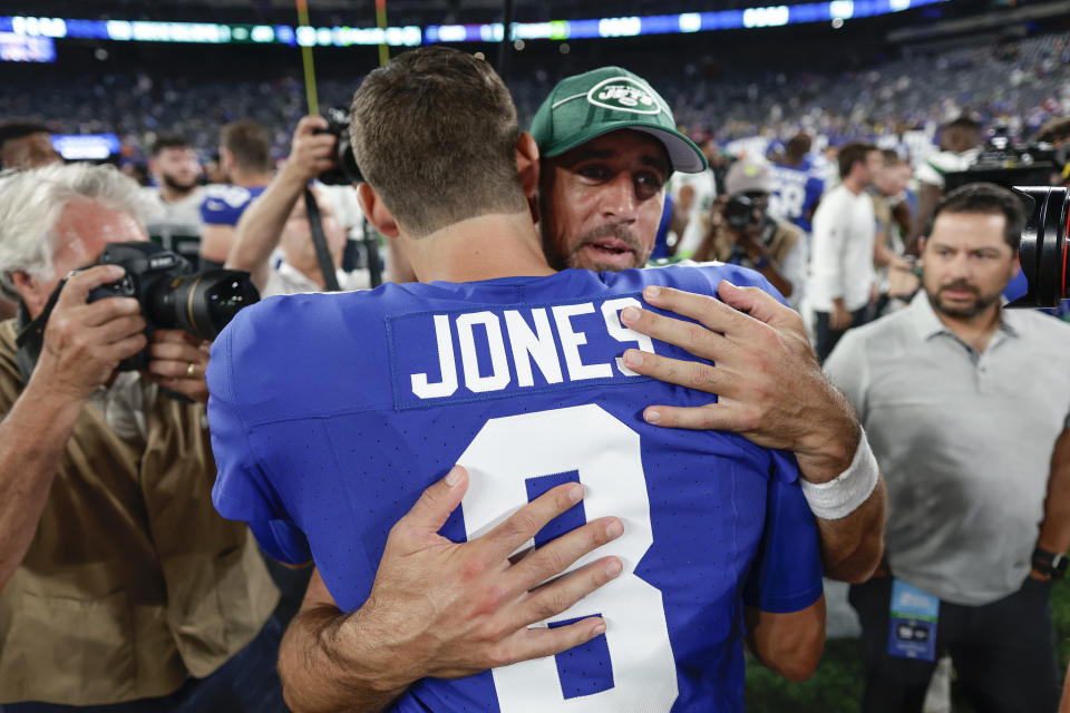 New York Jets quarterback Aaron Rodgers (8) greets New York Giants quarterback Daniel Jones (8) after an NFL preseason football game, Saturday, Aug. 26, 2023, in East Rutherford, N.J. (AP Photo/Adam Hunger)