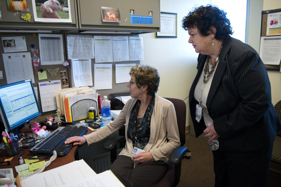 Lauren Peters, Director of Women's Health for Kaiser Permanente Outpatient Clinics in part of Sacramento, California, confers with business ine manager Sherwood Sterling. Peters does not plan on tapping in to her company's pension plan for at least a decade, probably more. (Autumn Payne/Sacramento Bee/Tribune News Service via Getty Images)