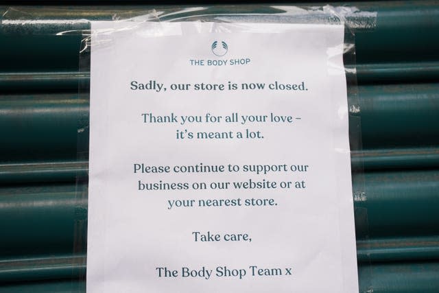 A sign on the shutters of the Body Shop store on Oxford Street in central London