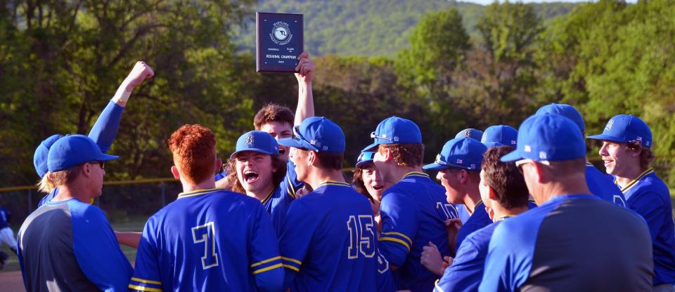 Clear Spring's Clayton Boyer holds up the Class 1A West Region II championship plaque as the Blazers celebrate their 13-5 win over Catoctin.