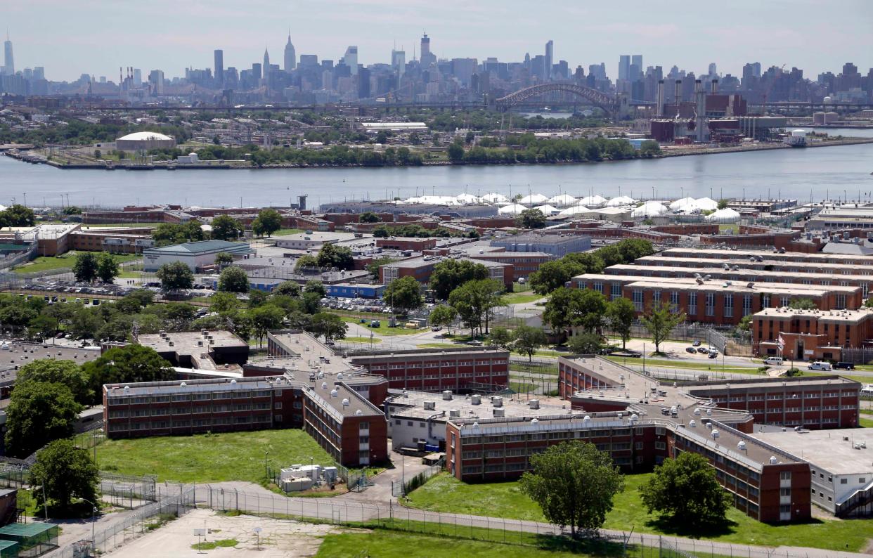 Aerial of the Rikers Island jail complex with the Manhattan, New York skyline in the background.