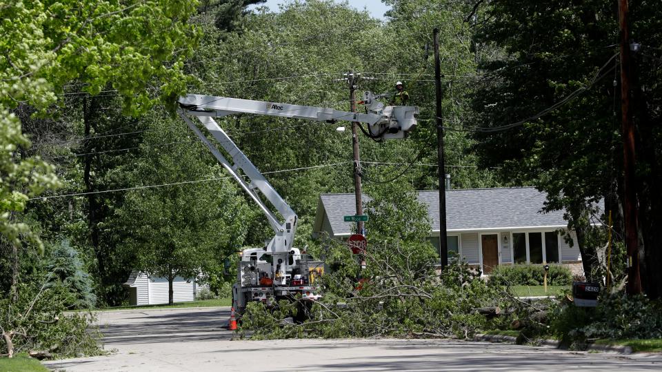 Wisconsin Public Service crews work to restore power to customers in Green Bay on June 16, 2022, after severe storms hit the area the day before.