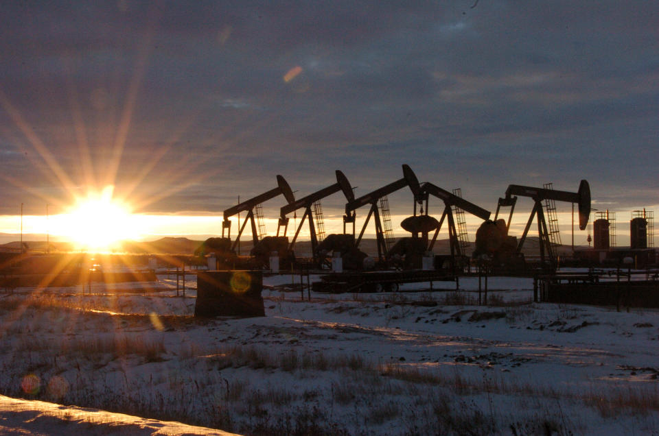 FILE - This Jan. 14, 2015 file photo shows oil pump jacks in McKenzie County in western North Dakota. Dozens of European lawmakers, business executives and union leader called Tuesday for the United States to cut its greenhouse gas emissions by 50% in the coming decade compared with 2005 levels. (AP Photo/Matthew Brown, File)