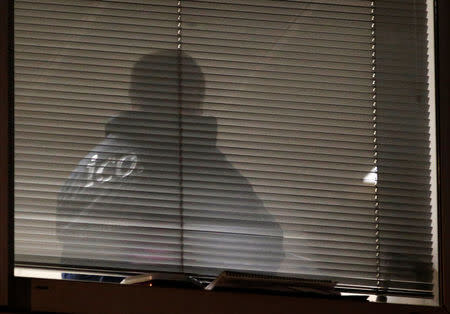 A person is seen inside the building which houses the offices of Cambridge Analytica as investigators from Britain's Information Commissioners Office entered, following the granting of a search warrant by a High Court judge, in London, Britain March 23, 2018. REUTERS/Henry Nicholls