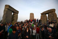 <p>Revellers watch the sun rise on the stones of the Stonehenge monument on the summer solstice near Amesbury, Britain, June 21, 2017. (Photo: Neil Hall/Reuters) </p>