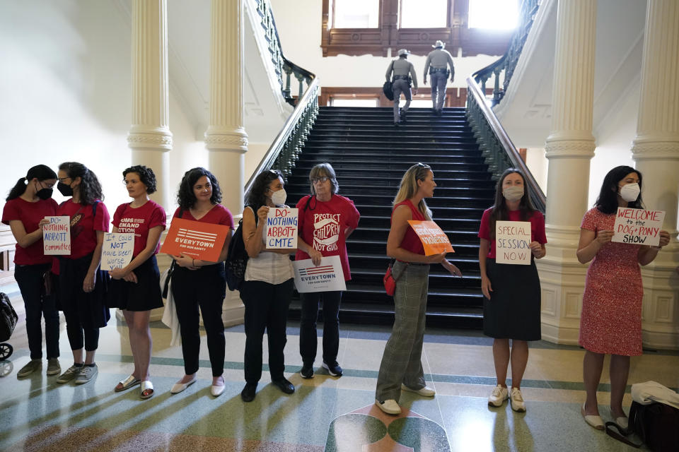 Women with Moms Demand Action gather outside the Texas Senate Chamber as the second day of a hearing begins, Wednesday, June 22, 2022, in Austin, Texas. The hearing is in response to the recent school shooting in Uvalde, Texas, where two teachers and 19 students were killed. (AP Photo/Eric Gay)