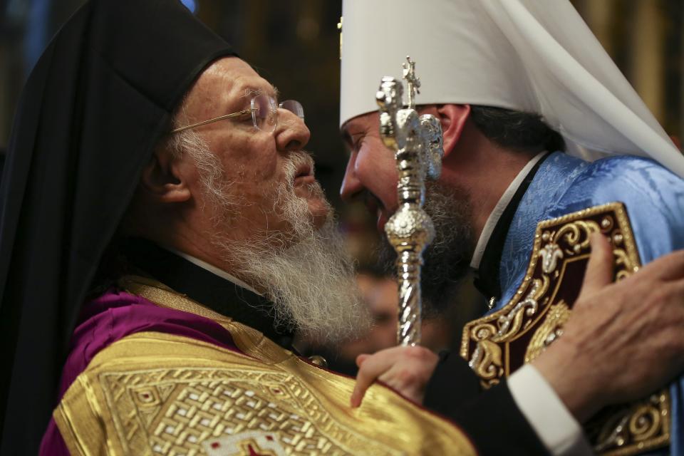 Ecumenical Patriarch Bartholomew I, left, and Metropolitan Epiphanius, the head of the independent Ukrainian Orthodox Church, greet each other during the ceremony of signing the "Tomos" decree of autocephaly for the Ukrainian church at the Patriarchal Church of St. George in Istanbul, Saturday, Jan. 5, 2019. The Ecumenical Patriarch of Constantinople has signed a decree of independence for the Orthodox Church of Ukraine. (AP Photo/Emrah Gurel)