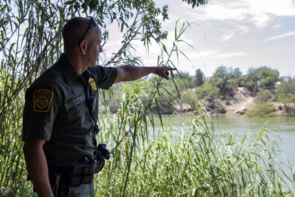 Border Patrol agent Carlos Ruiz points out an area of high traffic along the Rio Grande south of McAllen, Texas. 32 illegal immigrants were found during a sweep of the area in the span of 2 hours. (Photo: Sergio Flores for Yahoo News)