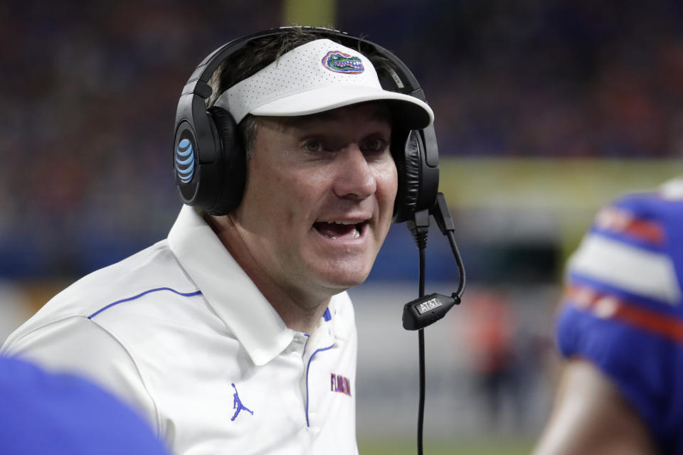 FILE - In this Dec. 30, 2019, file photo, Florida head coach Dan Mullen watches the second half of the Orange Bowl NCAA college football game against Virginia in Miami Gardens, Fla. No. 10 Florida resumed meetings and practices for the first time in two weeks Monday, Oct. 26, 2020. They got back to work after a COVID-19 outbreak caused the Southeastern Conference to postpone two of the team’s games. (AP Photo/Lynne Sladky, File)