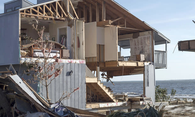 Furniture stands inside a damaged beach house after Hurricane Michael hit in Mexico Beach. Photographer: Zack Wittman/Bloomberg