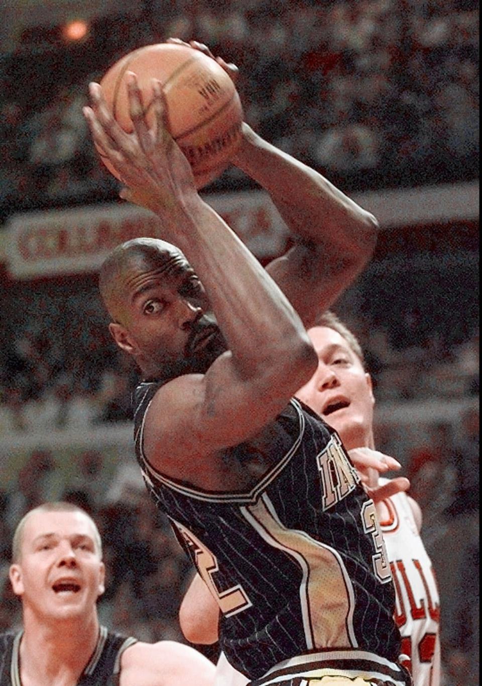 The Indiana Pacers' Dale Davis (32) grabs a rebound in front of teammate Rik Smits, left, and Chicago Bulls' Luc Longley, right, during the first quarter of the Game 2 in the Eastern Conference Finals Tuesday, May 19, 1998 in Chicago.