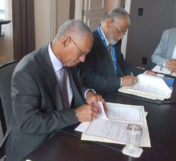 NASA Administrator Charles Bolden (left) and Chairman K. Radhakrishnan of the Indian Space Research Organisation sign documents on Sept. 30, 2014 to launch a joint Earth-observing satellite mission and establish a pathway for future joint missi