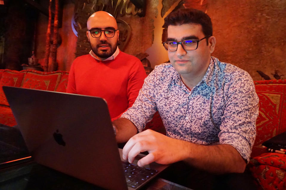 Certfa researchers Nariman Gharib, left, and Amin Sabeti look at a computer at a cafe in London on Friday, Dec. 7, 2018. The Associated Press drew on data gathered by the London-based cybersecurity group Certfa to track how a hacking group often nicknamed Charming Kitten spent the past month trying to break into the private emails of more than a dozen U.S. Treasury officials. Also on the hackers’ hit list: high-profile defenders, detractors and enforcers of the nuclear deal struck between Washington and Tehran, as well as Arab atomic scientists, Iranian civil society figures and D.C. think tank employees. (AP Photo/Raphael Satter)