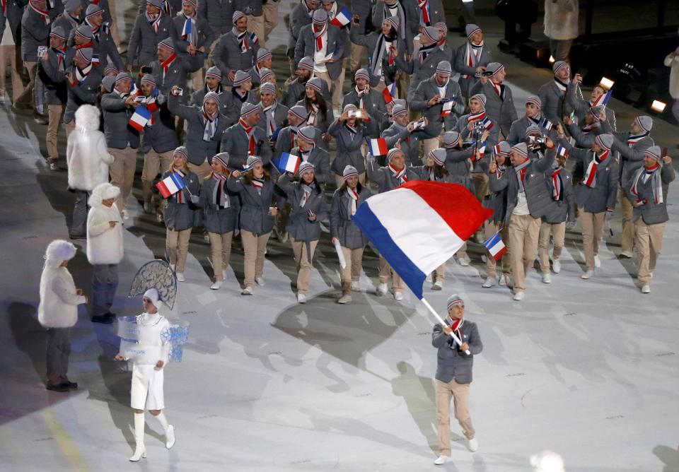 France's flag-bearer Jason Lamy Chappuis leads his country's contingent during the opening ceremony of the 2014 Sochi Winter Olympics, February 7, 2014. REUTERS/Issei Kato (RUSSIA - Tags: OLYMPICS SPORT)