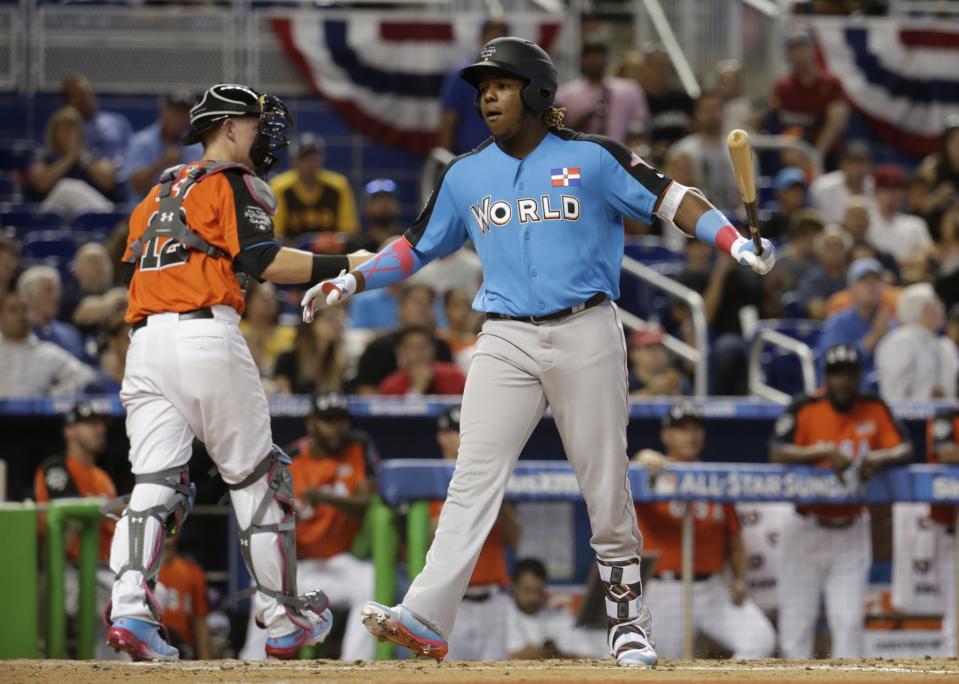 World Team's Vladimir Guerrero Jr., front right, of the Toronto Blue Jays, strikes out during the second inning of the All-Star Futures baseball game against the U.S. Team, Sunday, July 9, 2017, in Miami.