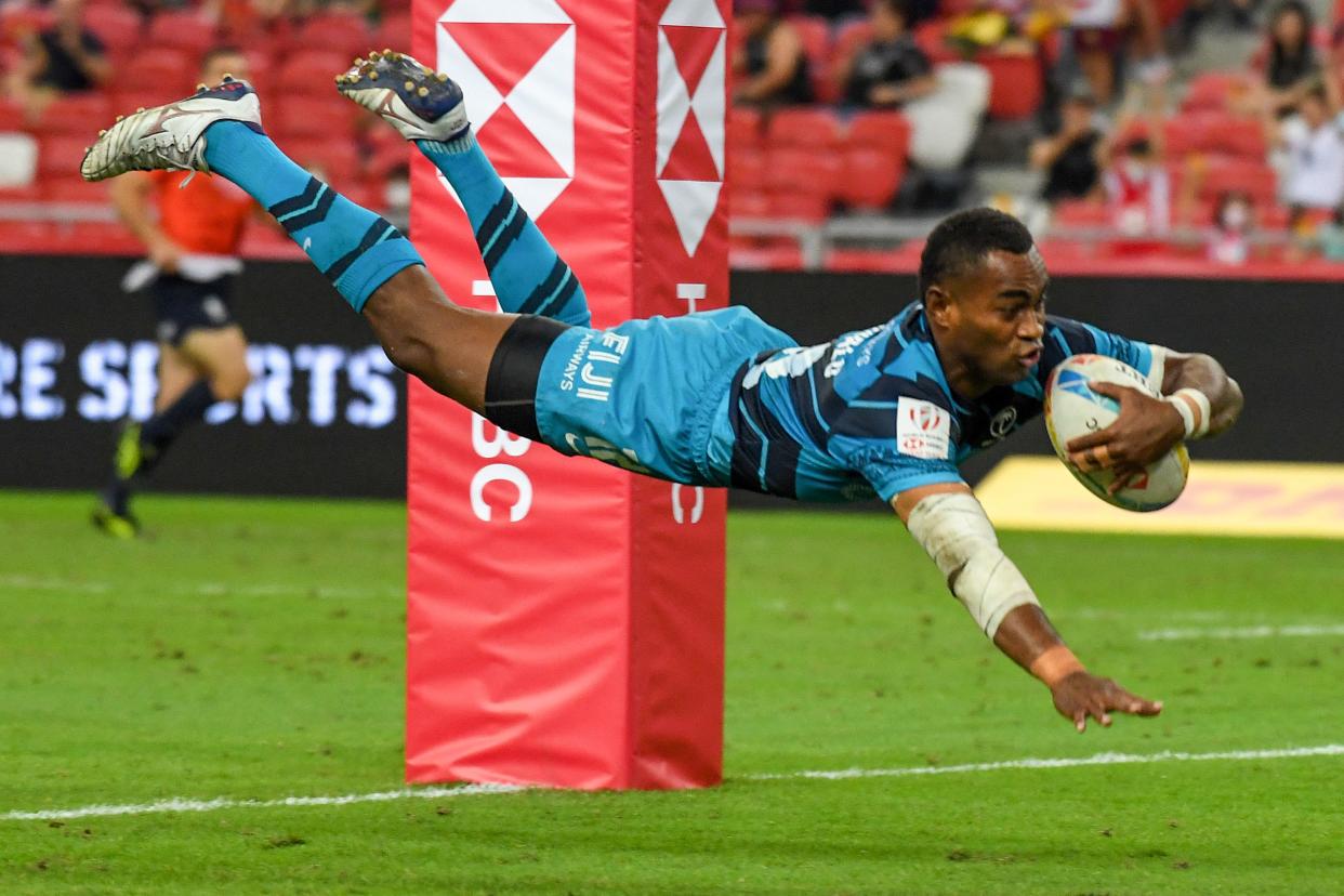 Fiji's Vuiviawa Naduvalo scores a try during the Singapore Rugby Sevens cup final match against New Zealand.