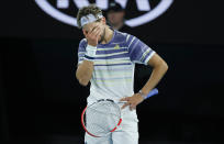 Austria's Dominic Thiem reacts during his match against Serbia's Novak Djokovic inthe men's singles final at the Australian Open tennis championship in Melbourne, Australia, Sunday, Feb. 2, 2020. (AP Photo/Dita Alangkara)