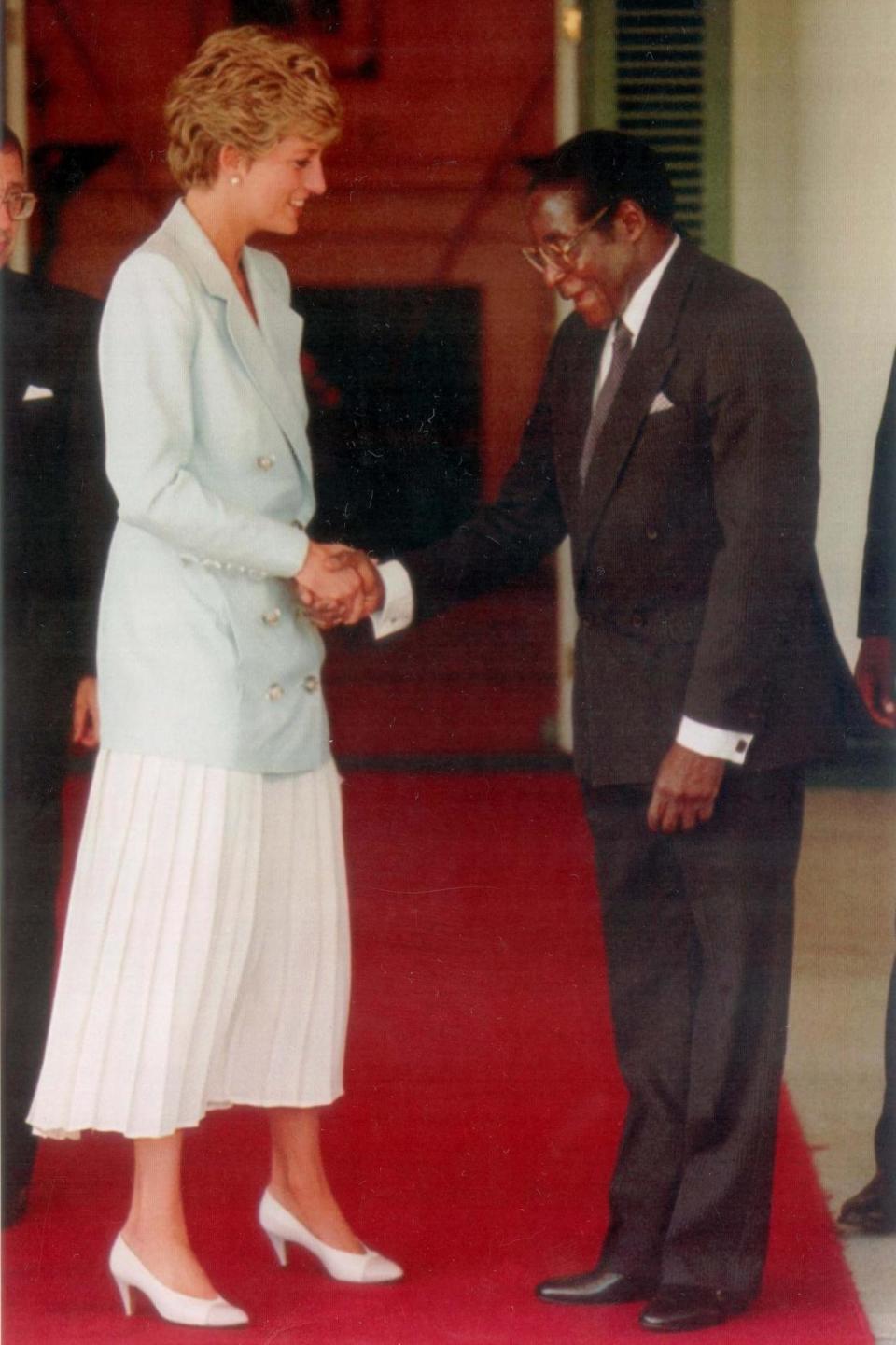 Diana greeting Mugabe during her visit to Zimbabwe, 1993.