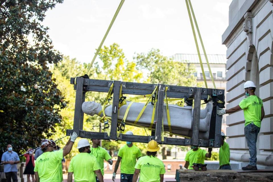 Workers use a crane to remove the Jefferson Davis statue from the Kentucky state Capitol in Frankfort, Ky., on Saturday, June 13, 2020.