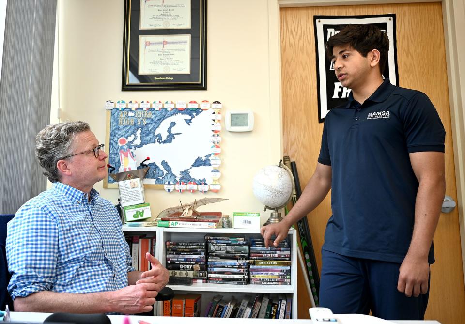 Aryan Kumar, right, of Shrewsbury, a senior at the Advanced Math and Science Academy in Marlborough, speaks with history teacher Anders Lewis after school, May 24, 2022. Kumar, 18, is one of just 161 students to be named a U.S. Presidential Scholar this year.