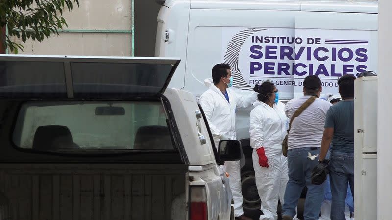 Forensic technicians are pictured outside a funeral parlor after transporting the bodies of inhabitants of an indigenous village killed by assailants, in an area that has been plagued by local disputes, in Salina Cruz