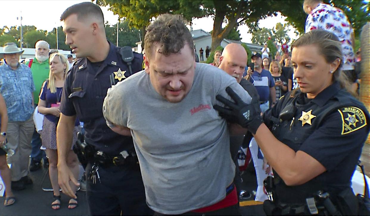 In this image taken from video provided by WHEC-TV, David Jakubonis, center, is taken into custody by Monroe County Sheriff deputies after he brandished a sharp object during an attack on U.S. Rep. Lee Zeldin, as the Republican candidate for New York governor delivered a speech in Perinton, N.Y., Thursday, July 21, 2022. 