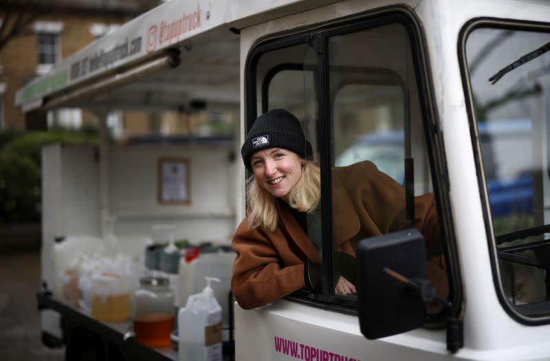 Ella Shone poses with her zero waste mobile shop 'Top Up Truck' in London