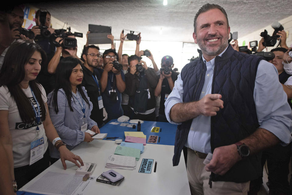 Roberto Arzu, presidential candidate of the PAN and Podemos party coalition, poses for photographers at a polling station during general elections in Guatemala City, Sunday, June 16, 2019. Guatemalans are voting for their next president in elections plagued by widespread disillusion and distrust, and as thousands of their compatriots flee poverty and gang violence to seek a new life in the United States. (AP Photo/Santiago Bill