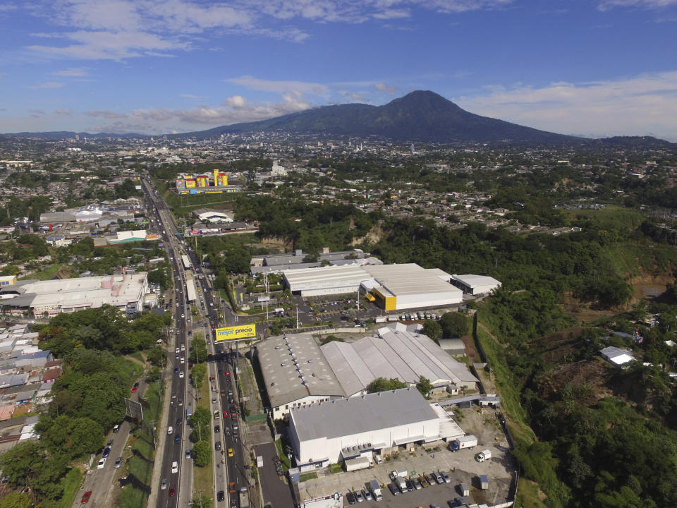 FILE - In this June 16, 2020 file photo, vehicles circulate on Army Boulevard, on the second day of the reopening of the economy, three-months after a lockdown aimed at preventing the spread of the new coronavirus in Soyapango, El Salvador. For months, the strictest measures confronting the COVID-19 pandemic in Latin America seemed to keep infections in check, in El Salvador, but a gradual reopening combined with a political stalemate has seen infections increase nearly fourfold by August. (AP Photo/Salvador Melendez, File)