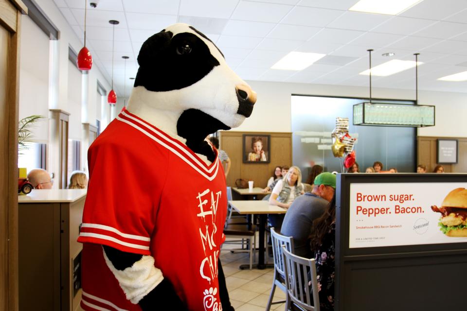 Chick-fil-A cow mascot stands in the lobby at the Glenstone location.