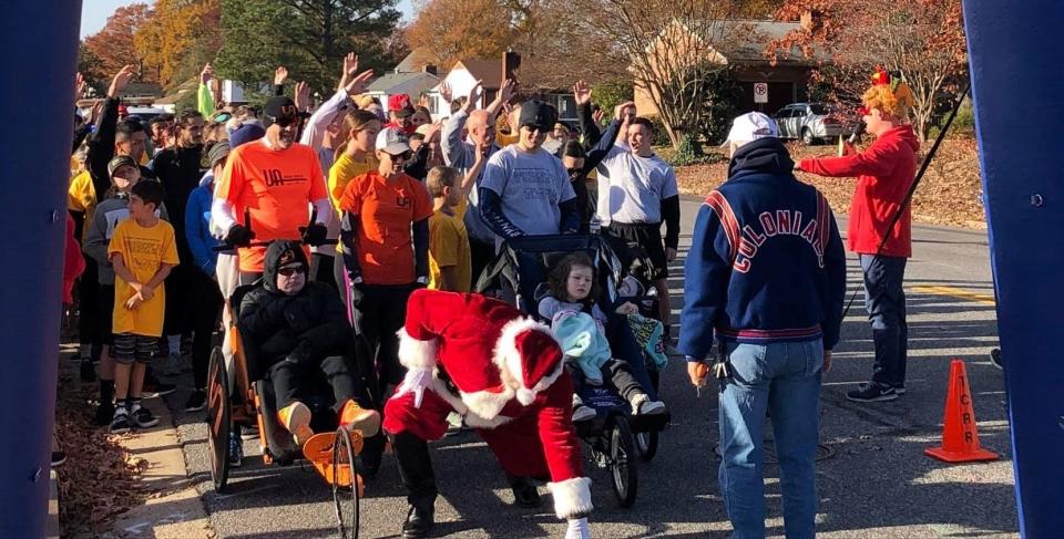 On Thanksgiving morning, Colonial Heights Chamber of Commerce 8th annual Turkey Trot participants ready themselves at the start of the 1K/5K Fun Runs...including Santa Claus; Chamber president Danny Bowles, on the right wearing a turkey hat, welcomes everyone.