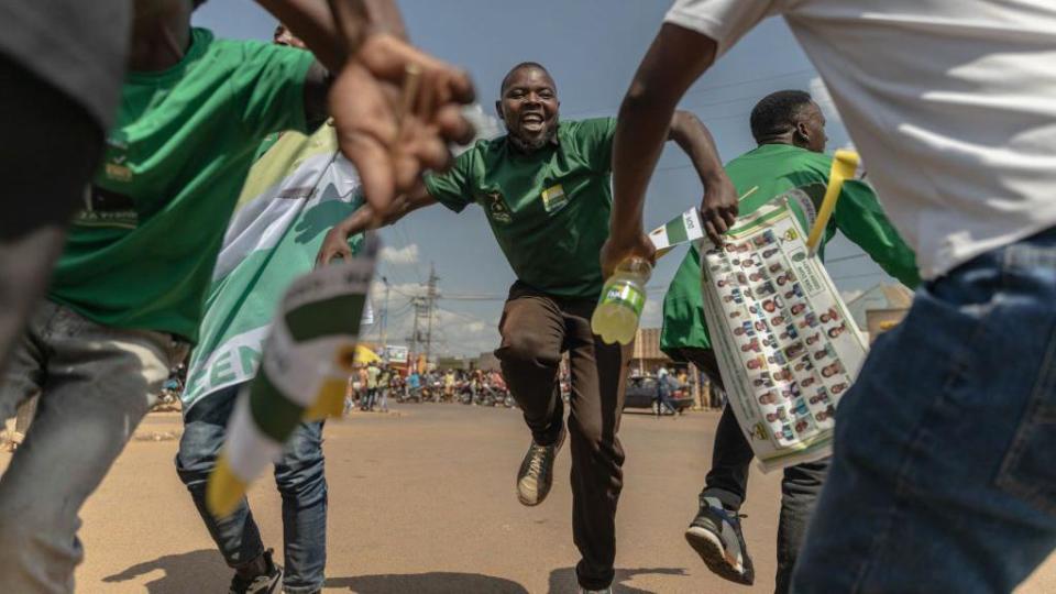 Supporters of the Democratic Green Party dance as they attend the party's political rally in Gihara, Rwanda, on June 23, 2024, ahead of the upcoming parliamentary and presidential elections in Rwanda.