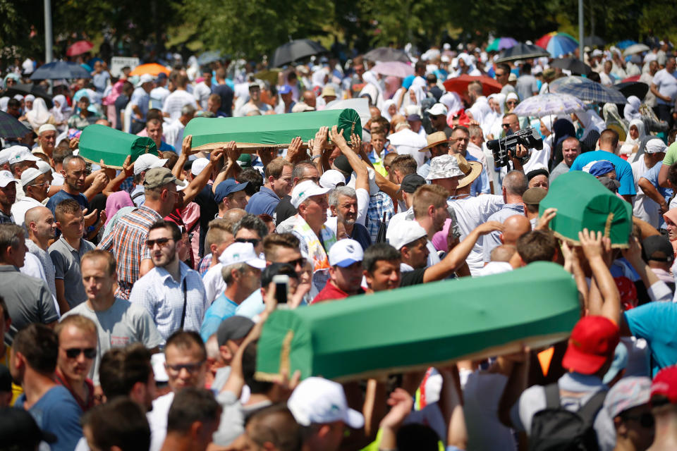 <p>People carry the coffin during a funeral ceremony of newly identified 71 Srebrenica genocide victims, to mark the 22nd anniversary of the Srebrenica genocide, at Potocari Memorial Center in Potocari village of Srebrenica, Bosnia and Herzegovina on July 11, 2017. (Photo: Mustafa Ozturk/Anadolu Agency/Getty Images) </p>