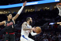 Los Angeles Clippers guard Amir Coffey, right, shoots in front of Portland Trail Blazers guard Anfernee Simons during the second half of an NBA basketball game in Portland, Ore., Wednesday, March 20, 2024. (AP Photo/Craig Mitchelldyer)