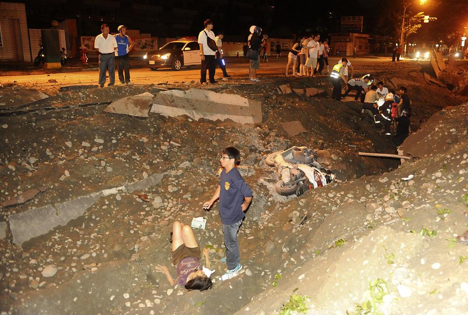 A person is seen lying on the ground after an explosion in Kaohsiung, southern Taiwan, August 1, 2014. An explosion caused by a gas leak in the southern Taiwanese city Kaohsiung has killed 15 people and injured another 243, Taiwanese media reported on Friday. REUTERS/Stringer (TAIWAN - Tags: DISASTER TPX IMAGES OF THE DAY)