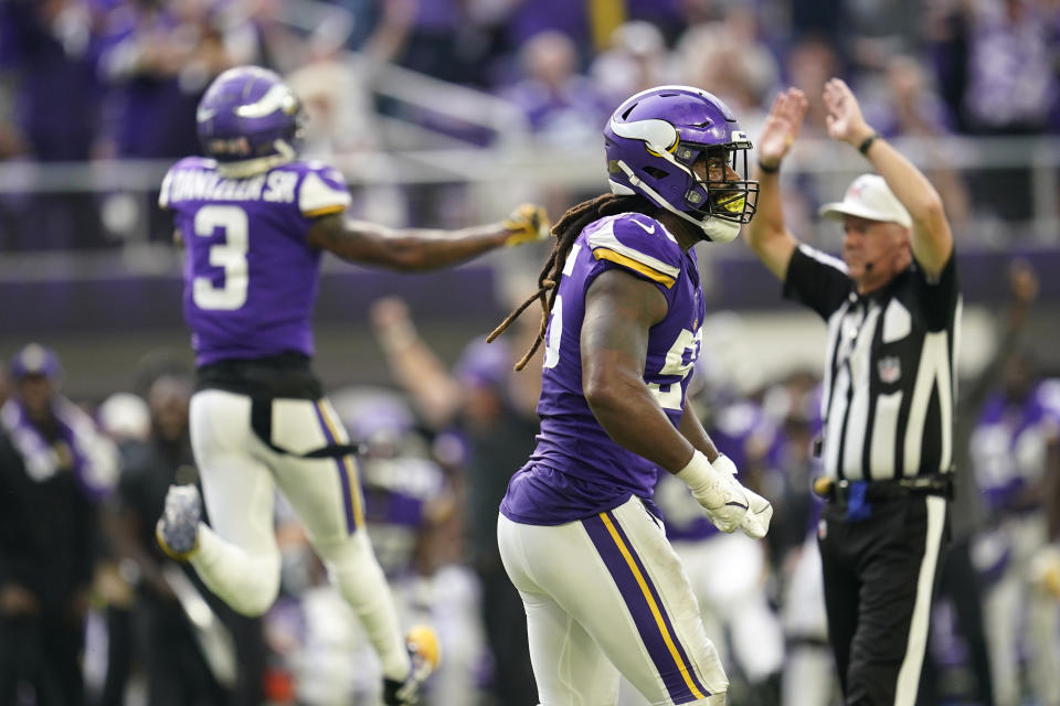 Minnesota Vikings linebacker Za'Darius Smith (55) and cornerback Cameron Dantzler (3) celebrate after a defensive stop during the first half of an NFL football game against the Green Bay Packers, Sunday, Sept. 11, 2022, in Minneapolis. (AP Photo/Abbie Parr)