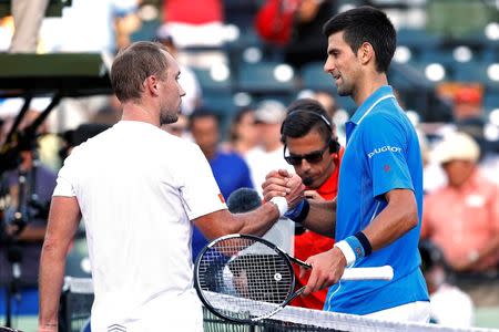 Novak Djokovic (right) shakes hands with Steve Darcis (left) after their match on day eight of the Miami Open at Crandon Park Tennis Center. Djokovic won 6-0, 7-5. Mandatory Credit: Geoff Burke-USA TODAY Sports