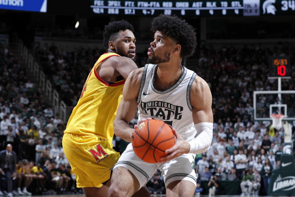 Michigan State forward Malik Hall, right, maneuvers to shoot against Maryland forward Donta Scott during the second half of an NCAA college basketball game, Saturday, Feb. 3, 2024, in East Lansing, Mich. (AP Photo/Al Goldis)