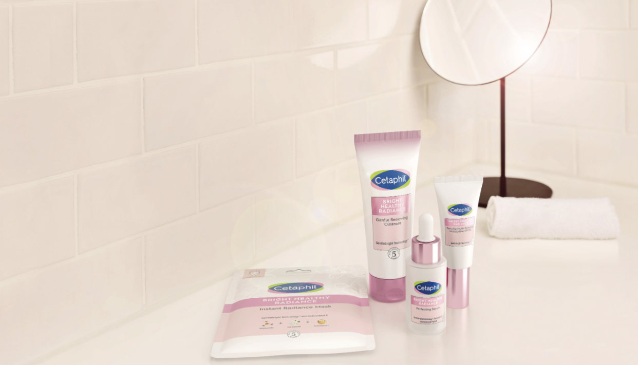 Cetaphil's new range of Bright Healthy Radiance skincare which includes the mask, cleanser, serum and sunscreen are displayed in a bathrooms setting with a mirror and towel in the background. 