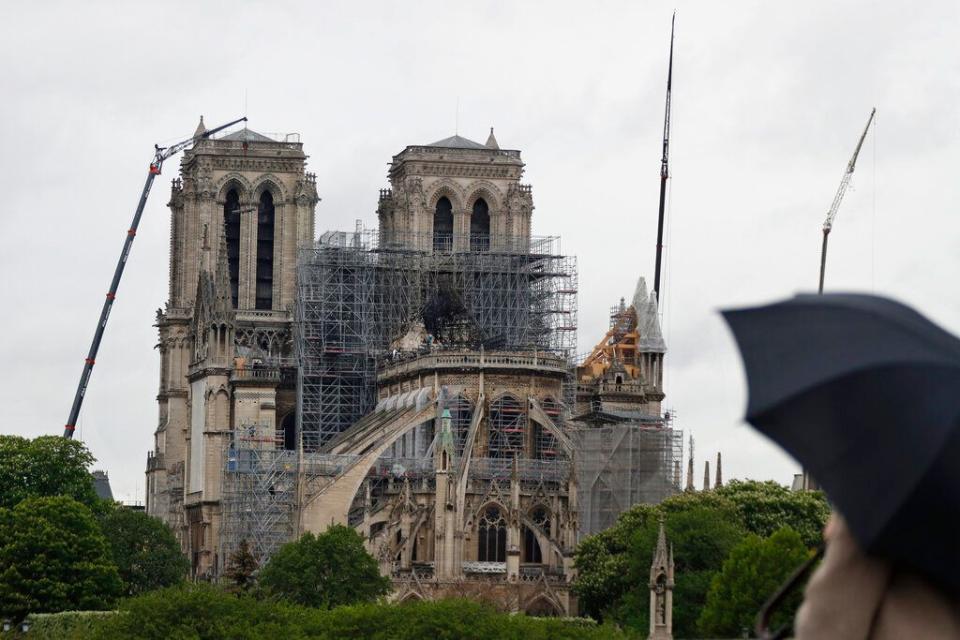 Cranes work at Notre Dame cathedral, in Paris, Thursday, April 25, 2019. French police scientists were starting to examine Notre Dame Cathedral on Thursday for the first time since last week's devastating fire.