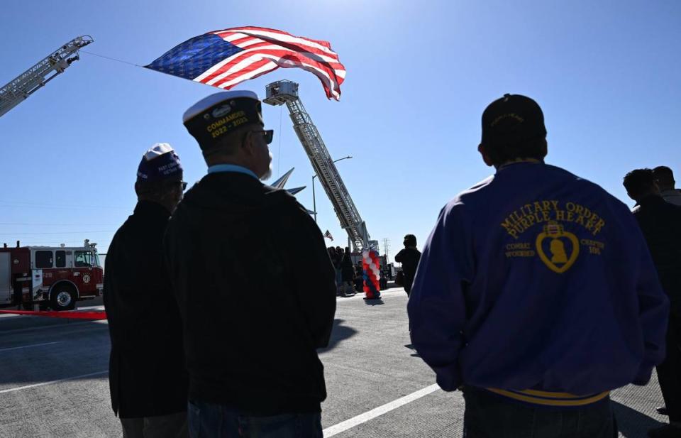 Veterans stand on the Veterans Boulevard overpass waiting for the start of the ribbon-cutting ceremony Monday, Nov. 20, 2023 in Fresno.