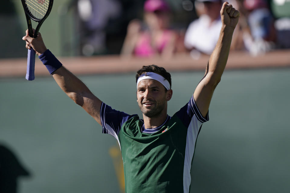 Grigor Dimitrov, of Bulgaria, celebrates after defeating Daniil Medvedev, of Russia, at the BNP Paribas Open tennis tournament Wednesday, Oct. 13, 2021, in Indian Wells, Calif. (AP Photo/Mark J. Terrill)