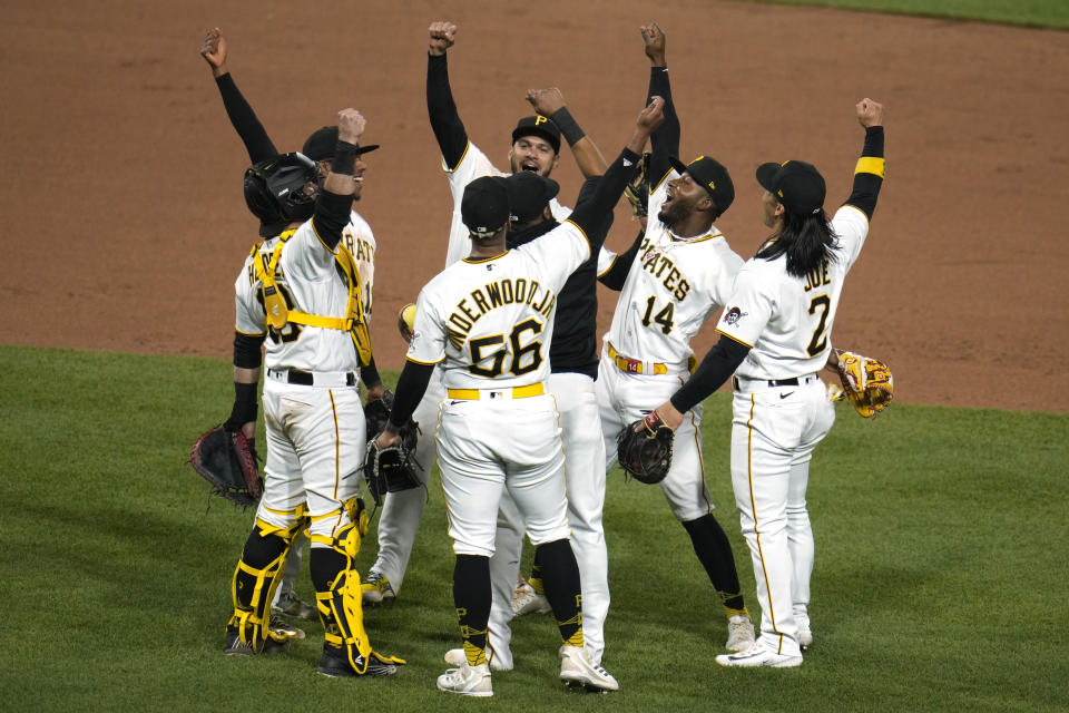 The Pittsburgh Pirates celebrate after getting the final out of a 2-1 win over the Cincinnati Reds in a baseball game in Pittsburgh, Saturday, April 22, 2023. (AP Photo/Gene J. Puskar)