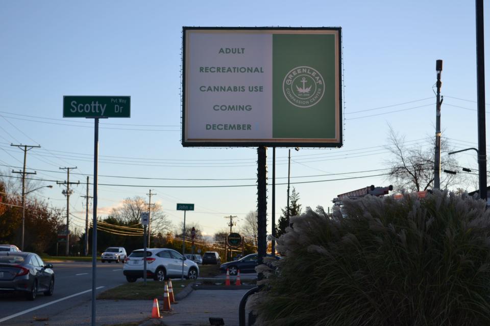 A sign on West Main Road signals the beginning of recreational marijuana sales at Greenleaf Compassion Center in Portsmouth.