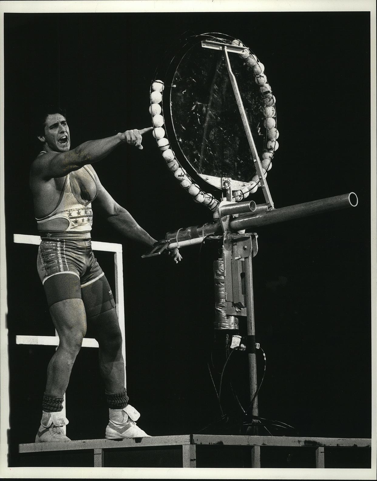 Gladiator Steve Henneberry, then 28, handles a tennis ball cannon during the game "Assault," on "American Gladiators" in 1991. The Netflix series profiling the show's brief but fascinating tenure includes an episode on the Gladiators tour across the country, which included a stop at the Milwaukee Arena.