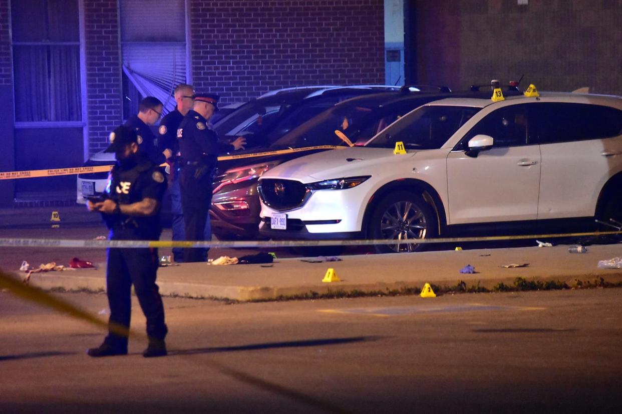 Toronto police at the scene of a fatal shooting in the parking lot of an Etobicoke high school late Sunday. (CBC - image credit)