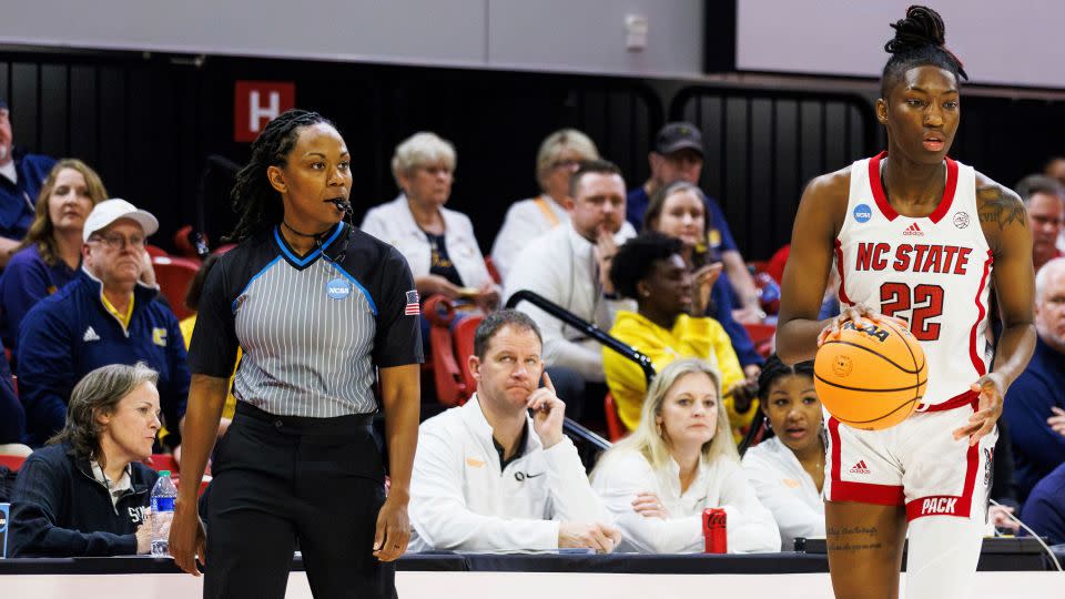 Tommi Paris (left) watches as NC State's Saniya Rivers handles the ball during the first half the game against Chattanooga. - Ben McKeown/AP