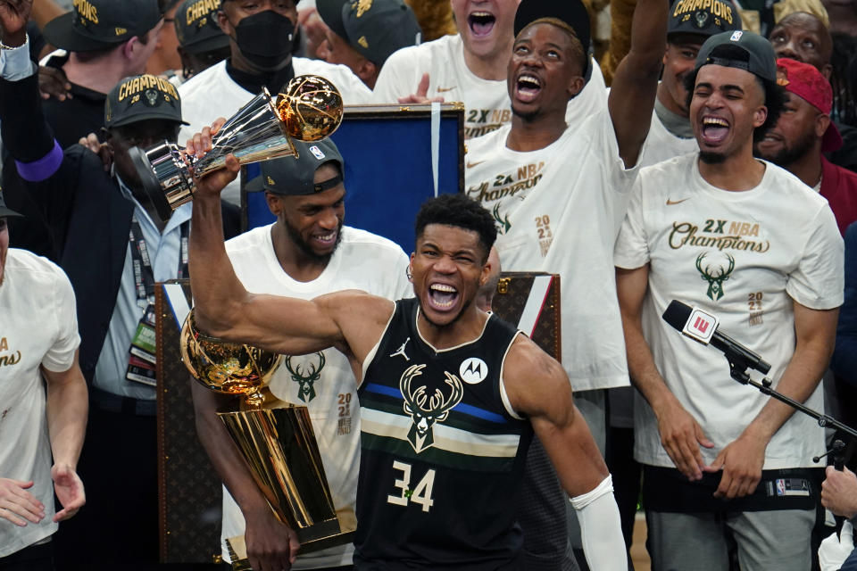 Milwaukee Bucks forward Giannis Antetokounmpo (34) holds the finals MVP trophy after the Bucks defeated the Phoenix Suns in Game 6 of basketball's NBA Finals in Milwaukee, Tuesday, July 20, 2021. The Bucks won 105-98. (AP Photo/Paul Sancya)