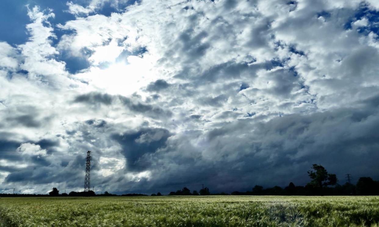 <span>Clouds over a field in Dunsden, Oxfordshire, on Monday.</span><span>Photograph: Geoffrey Swaine/Rex/Shutterstock</span>